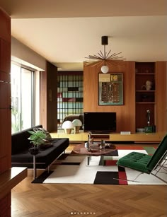 a living room filled with furniture and a flat screen tv on top of a wooden shelf