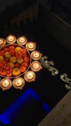 a bowl filled with lots of candles sitting on top of a table