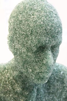 a close up view of a statue made out of green material and glittery fabric