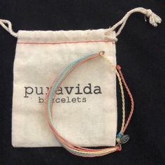 Pura Vida Bracelet. Never Worn. Strings Are Blue, Yellow, Coral Handmade Blue Bracelets For Everyday, Casual Multicolor Friendship Bracelets For Everyday, Casual Multicolor Everyday Friendship Bracelets, Casual Blue Bracelets For Everyday Use, Casual Blue Bracelets For Everyday, Adjustable Multicolor Bracelets, Handmade Multicolor Bracelets For Everyday Use, Puravida Bracelet, Jewelry Pura Vida