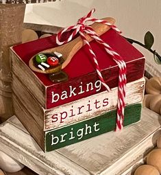 a wooden box that has some candy on top of it with the words baking spirits bright