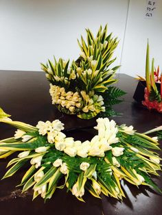 two vases with flowers on top of a table