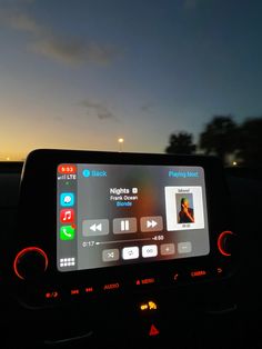 the dashboard of a car at night with an app on it's display screen