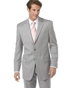 a man in a gray suit and pink tie