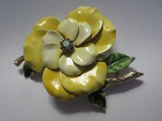 "By Art Mode Jewelry company, who made fine costumer jewelry from 1940s into the 1970s, this is an excellent quality similar to Hollycraft with their quality AB rhinestone. Lovely vintage large enamel brooch is almost 3\" by over 2\" and has beautifully shaded tones of yellow on two layers of petals with a large pink Aurora Borealis rhinestone as the focal point in the center.  Green leaves are also shaded well, with a textured, shining golden stem on each side. Hallmarked \"ART ©\" on one stem, Pink Aurora Borealis, Radko Christmas Ornaments, Double Photo Frame, Pink Aurora, Simplicity Patterns Dresses, Aprons Patterns, Vintage Bakelite, Enamel Brooch, Fall Fabric