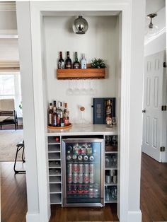 a home bar with bottles and glasses on the shelves