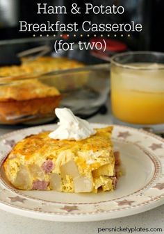 ham and potato breakfast casserole for two on a plate with orange juice in the background