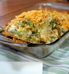 a casserole dish filled with green beans and other toppings on a table