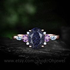 "This is a lab blue sandstone engagement ring in solid gold,about 6x8mm oval cut. The accent stones are natural 3mm amethyst,round opals and marquise cut 1.5x3mm topaz. The band width is about 1.4mm. It can be made in any ring size. However please contact me to custom make it to a special big or small size. It can be made in white gold,rose gold or yellow gold with 14k or 18k. However for some people who are nickel allergic,I can also make it to 925 sterling silver to make you can wear it. The r Elegant Gemstones With Prong Setting For Promise Ring, 14k Gold Jewelry With Sapphire And Gemstone Accents, Dazzling Multi-stone Sapphire Jewelry, Sapphire Jewelry With Gemstone Accents In 14k Gold, Elegant Cubic Zirconia Gemstones For Promise Ring, Fine Jewelry With Sapphire And Gemstone Accents, Rose Gold Sapphire Jewelry With Multi-stone, Rose Gold Multi-stone Sapphire Jewelry, Rose Gold Sapphire Multi-stone Jewelry