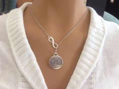 This necklace has cute little 1/2 inch tree of life round charm hanging lariat style with a Infinity connector thou 18inch silver plated chain. . Cute and trendy, this is unique and great as a gift! 18 inch chain with barrel clasp for closure. Silver Lariat Necklace With Round Pendant As Gift, Gift For Mothers Day, Tree Of Life Necklace, Necklace Gift, Mother Day Gifts, Tree Of Life, Gift Necklace, Mother Gifts, Mothers Day