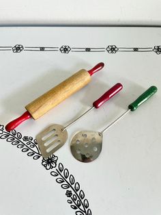 four different kitchen utensils on a table