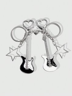 two guitar keys are attached to each other with hearts and stars in the shape of guitars