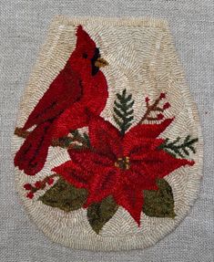 a red bird sitting on top of a poinsettia