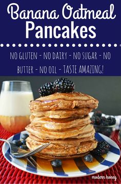 banana oatmeal pancakes on a plate with blueberries and blackberries in the background