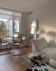 a living room filled with furniture next to a window