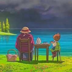 a man sitting at a table next to a little boy in front of a lake