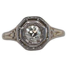 an old cut diamond ring with filigrees