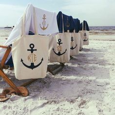 there are many bags on the beach with an anchor