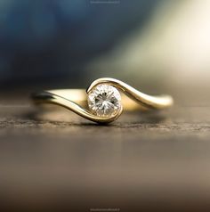 a gold ring with a diamond on it