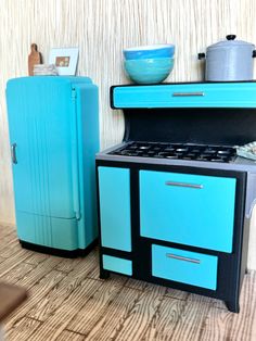 a blue stove top oven sitting next to a refrigerator