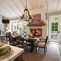 a dining room with a fireplace and table full of food on the kitchen counter top