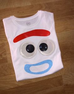 a white t - shirt with googly eyes on it