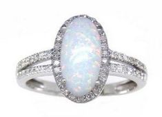 Stunning Created Simulated Opal & Cubic Zirconia Ring. Featuring a 12x6 Oval Center (1/2"x 1/4") And 50 Round CZS. The opal is the centerpiece of this gorgeous ring, with its vibrant and beautiful colors. The glistening czs that surround it, only enhance its beauty and give it an heirloom like quality. Opal is the birthstone for October. This ring is available in all the birthstone colors both in lab created and genuine stones. It is also available  in 10k, 14k yellow, white and rose gold White Oval Ring With Stones, White Oval Rings With Stones, Opal And Diamond Ring, Gorgeous Ring, Birthstone Colors, Cubic Zirconia Rings, October Birthstone, October Birth Stone, White Rose Gold