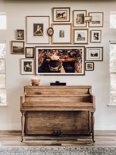 a piano in front of a wall with pictures on it