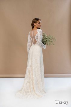 a woman in a wedding dress holding flowers