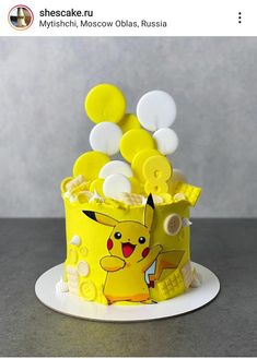 a pokemon themed cake with buttons on it's top and the words, myshiki moscow ollasa, russian