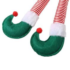 two green and white striped stockings with red pom - poms