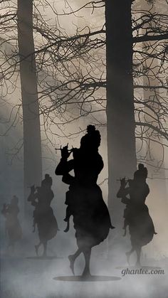 silhouettes of people running through the foggy woods with trees in the foreground