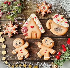 gingerbread cookies decorated with icing and candy canes on a wooden board surrounded by christmas decorations