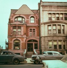 old cars are parked in front of an older building