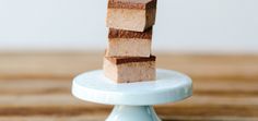 a stack of brownies sitting on top of a blue plate