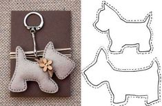 a keychain shaped like a dog with a flower in its mouth and the shape of a poodle attached to it