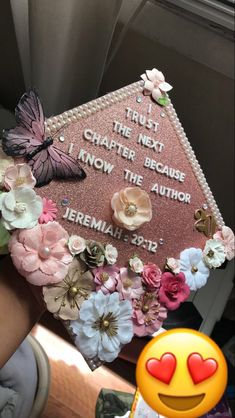 a pink graduation cap decorated with flowers and butterflies