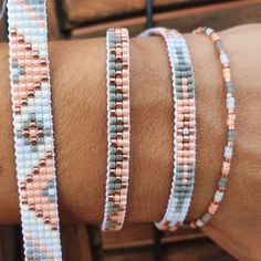 a close up of a person's arm wearing bracelets with beads on it