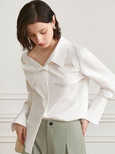 This is a modern and feminine top by yyiam that is made out of high quality and sturdy fabric. With unique design detail and trendy mood, you can style it for your clean and casual daily outfit.- Buttons detail on the shoulder- Unique collar neckline detail- Relaxed feminine silhouette Elegant Asymmetrical Cotton Top, Chic Asymmetrical Shirt For Office, Chic Asymmetrical Office Shirt, White Asymmetrical Tops For Work, White Asymmetrical Tops For Workwear, Elegant Asymmetrical Blouse For Office, Chic Asymmetrical Cotton Shirt, White Tops For Office Wear In Fall, White Top For Office Wear In Fall