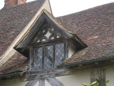 an old building with a wooden window and roof