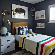 a bed room with a neatly made bed and two pictures on the wall above it