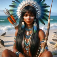 a native american woman sitting on the beach with feathers and arrows in her hand,