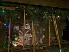 a christmas display in the window of a building with lights on it and decorations around