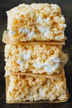 three pieces of rice krispy treats stacked on top of each other with marshmallows