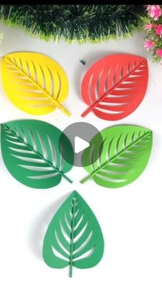 four paper leaves are arranged in the shape of three different colors, one green and one red