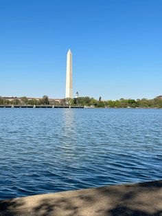 the washington monument is seen from across the water