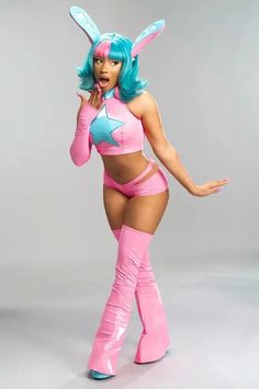 a woman dressed in pink and blue with bunny ears on her head is posing for the camera