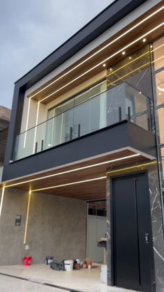 a modern house with glass balconies and lights