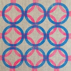 a blue and pink pattern on fabric with circles in the center, all drawn by hand