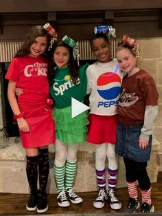 three girls in costumes standing next to each other with soda cans on their heads and socks